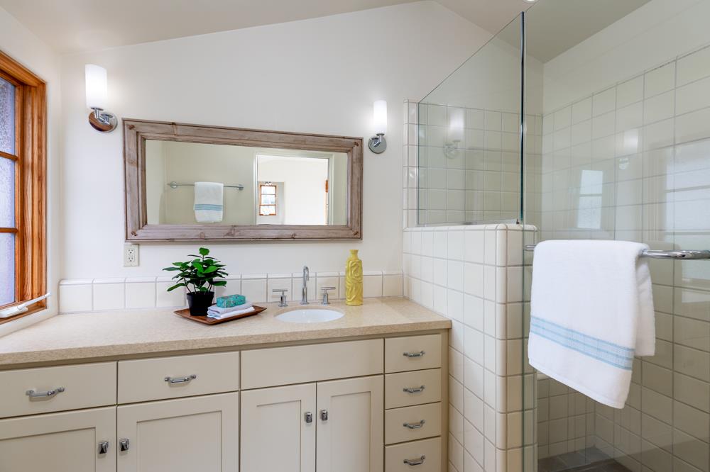 244 Aptos Beach Drive Aptos, CA 95003 - Photo 15 of 32 a bathroom with a sink a mirror and a shower
