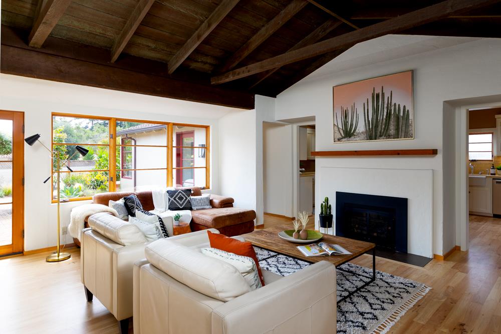244 Aptos Beach Drive Aptos, CA 95003 - Photo 2 of 32 a living room with furniture a fireplace and a large window