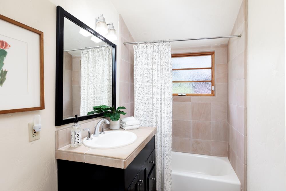 244 Aptos Beach Drive Aptos, CA 95003 - Photo 21 of 32 a bathroom with a sink and a mirror