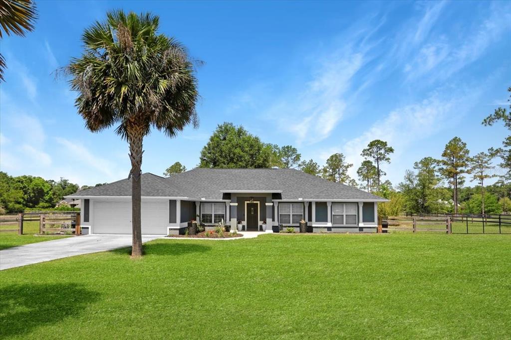 20680 Northwest 250th Street High Springs, FL 32643 - Photo 1 of 28 a front view of a house with garden