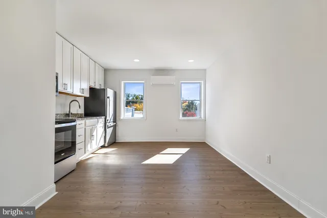 a view of kitchen with wooden floor and electronic appliances