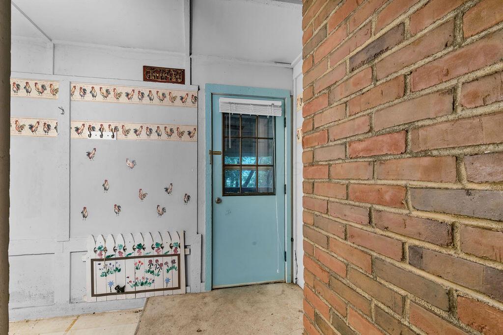 4409 Newton Road Northeast Newark, OH 43055 - Photo 30 of 87 • Light sand carpet • Ivory painted walls • Shelving • Wall hooks • Door to covered rear deck