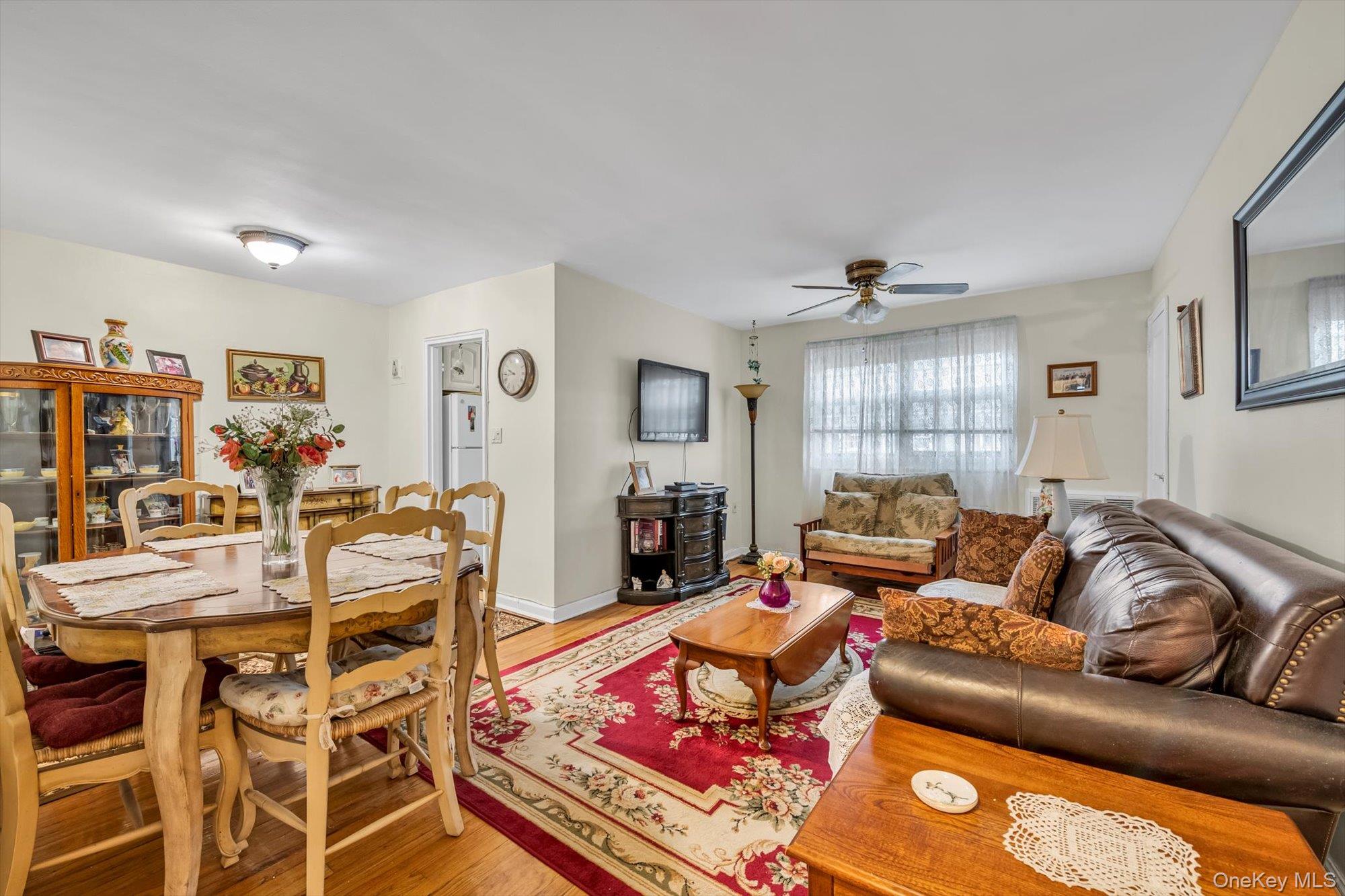 69-18 Bell Boulevard, Unit B Queens, NY 11364 - Photo 3 of 9 a living room with furniture and wooden floor