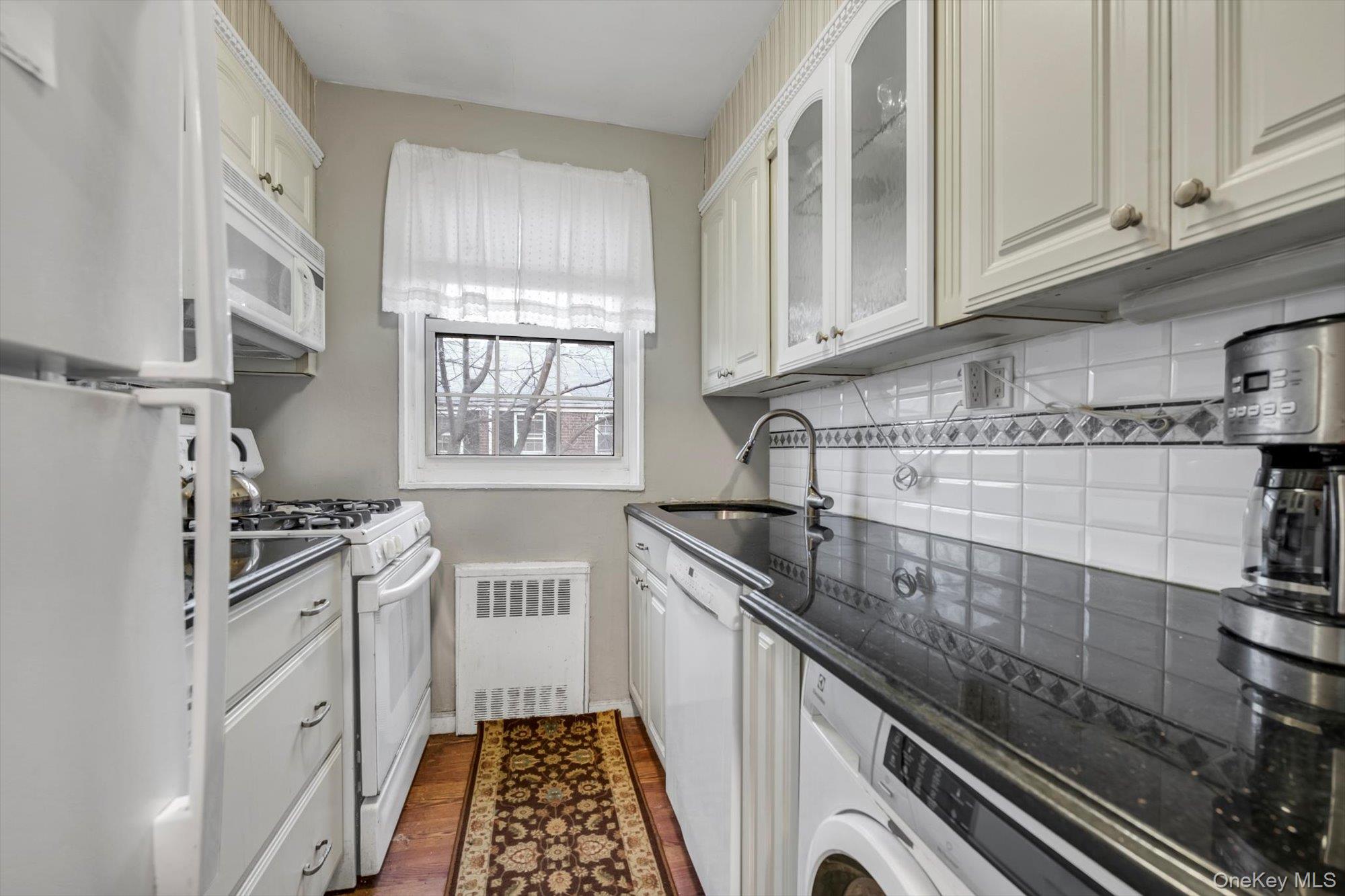 69-18 Bell Boulevard, Unit B Queens, NY 11364 - Photo 6 of 9 a kitchen with granite countertop a stove and a sink