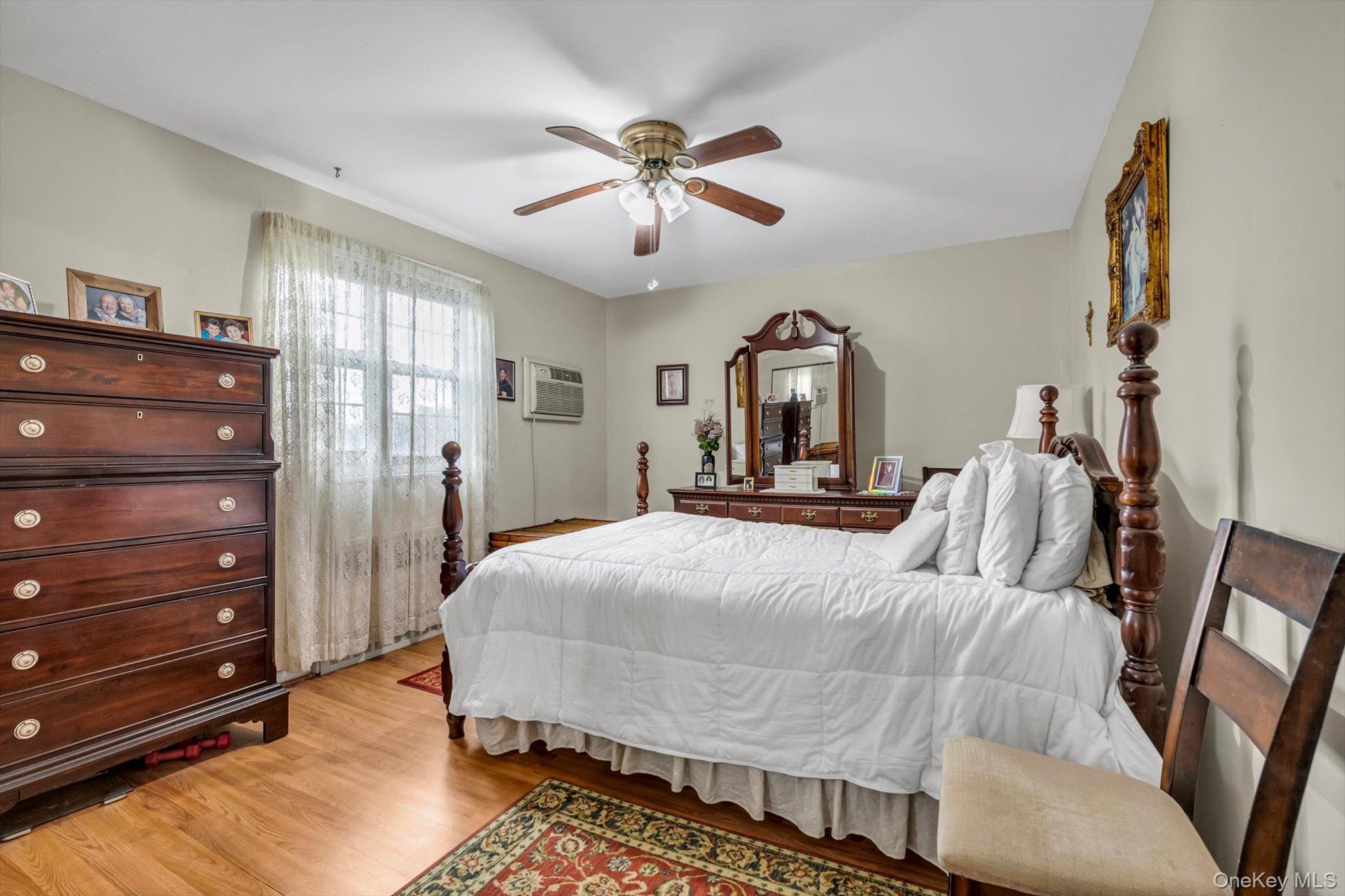 69-18 Bell Boulevard, Unit B Queens, NY 11364 - Photo 7 of 9 a bedroom with a bed and ceiling fan