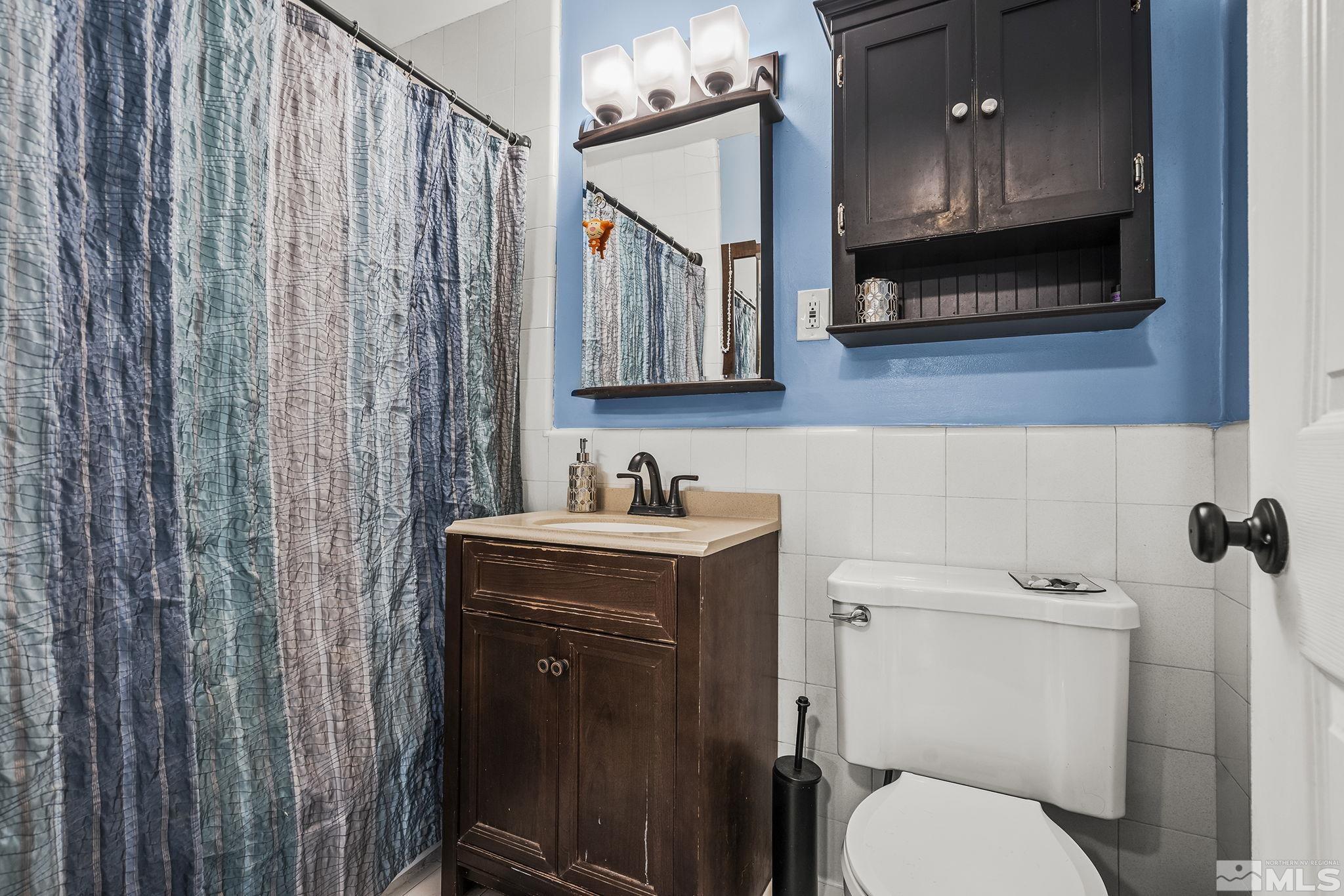 13693 Mt Baldy Street Reno, NV 89506 - Photo 13 of 18 a bathroom with a sink a toilet and mirror