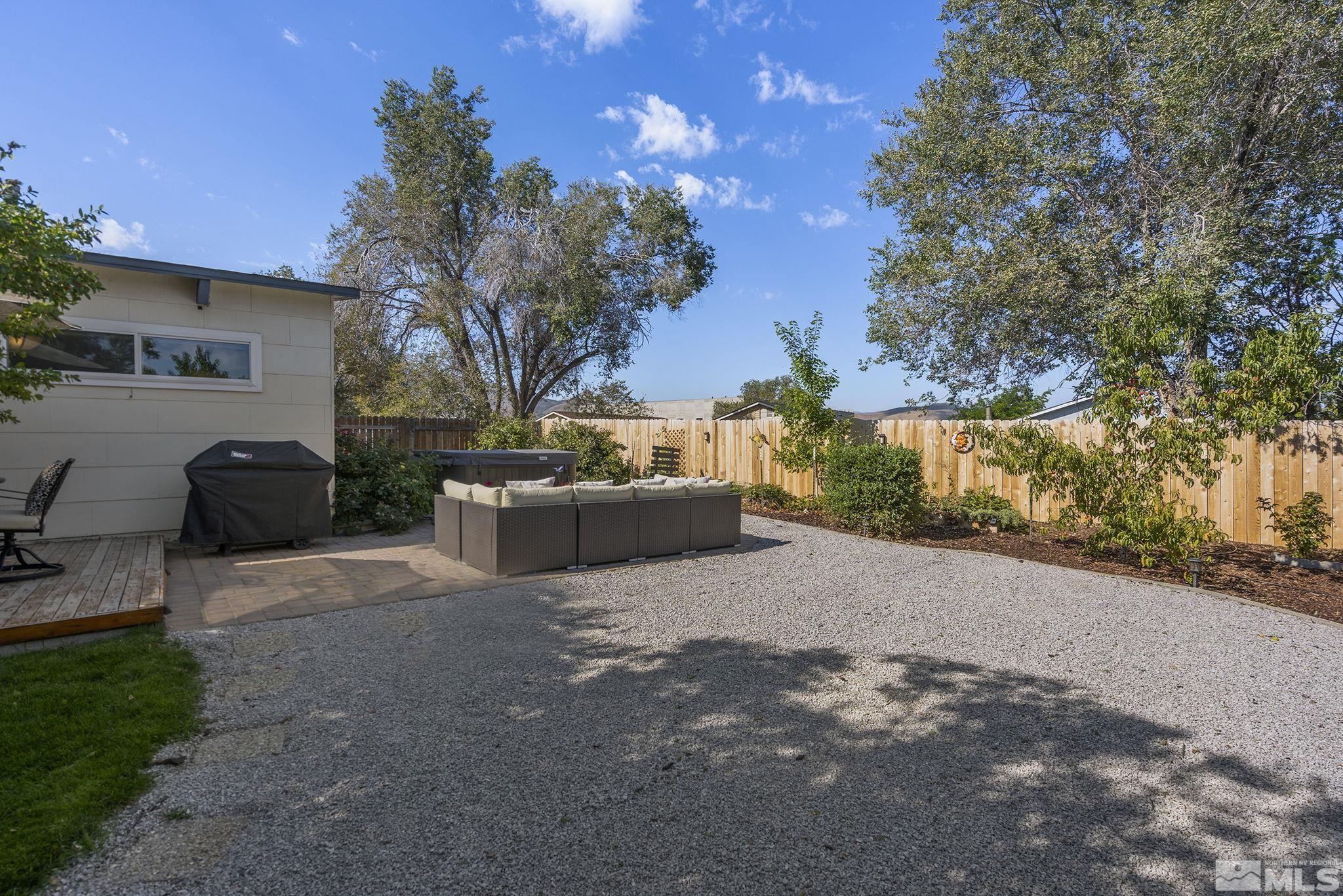13693 Mt Baldy Street Reno, NV 89506 - Photo 15 of 18 a view of a patio with couches and table and chairs under an umbrella