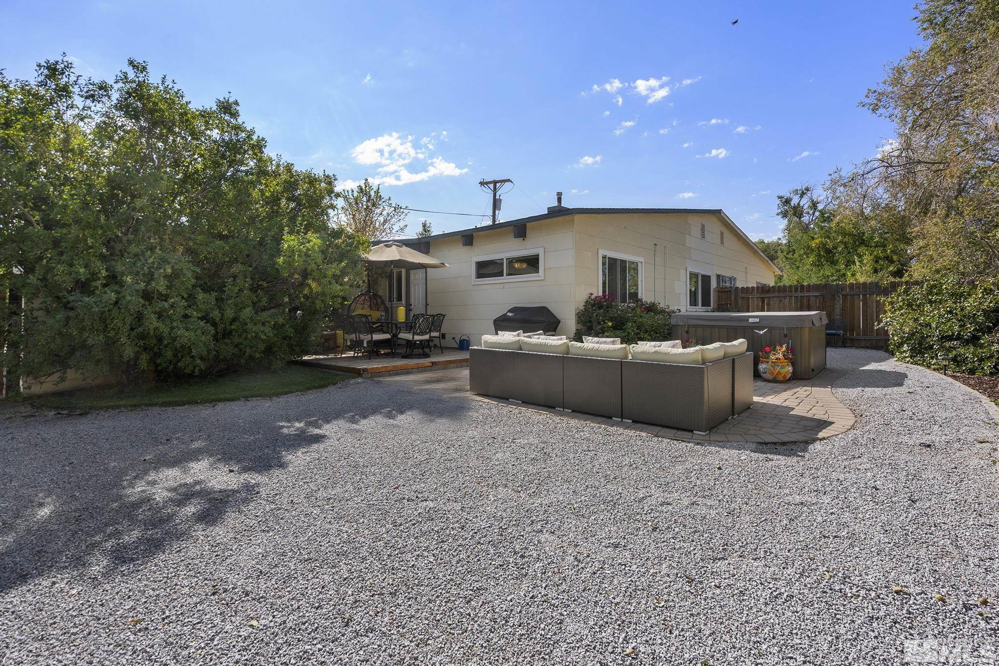 13693 Mt Baldy Street Reno, NV 89506 - Photo 16 of 18 a front view of a house with a big yard and potted plants