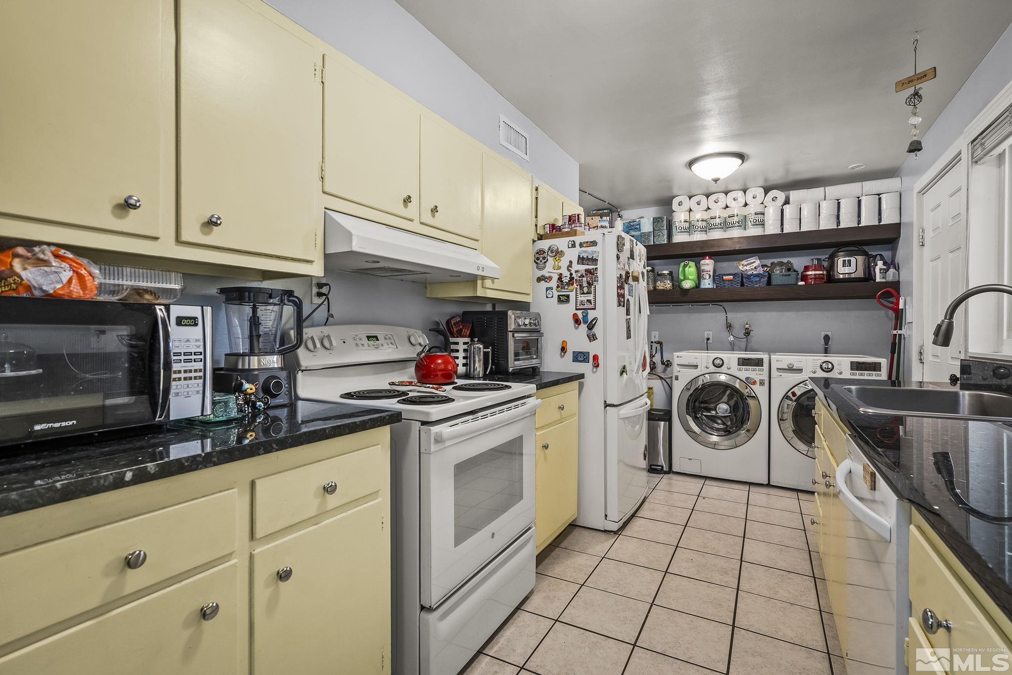 13693 Mt Baldy Street Reno, NV 89506 - Photo 7 of 18 a kitchen with a sink a stove and cabinets