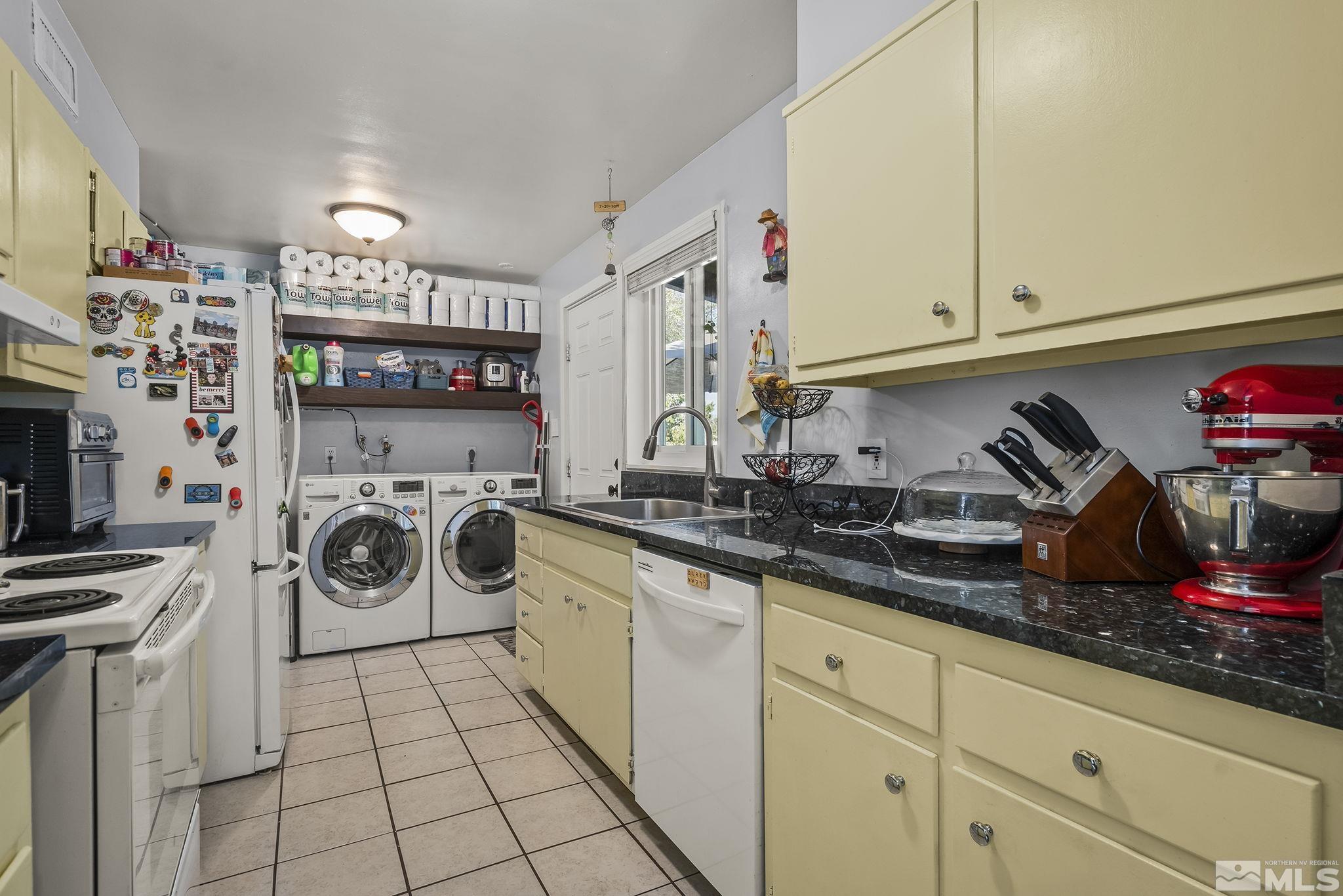 13693 Mt Baldy Street Reno, NV 89506 - Photo 8 of 18 a utility room with sink dryer and bicycles