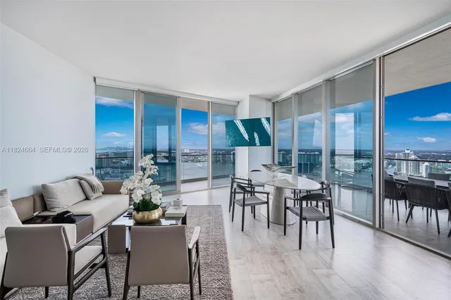 a dining room with furniture window and wooden floor
