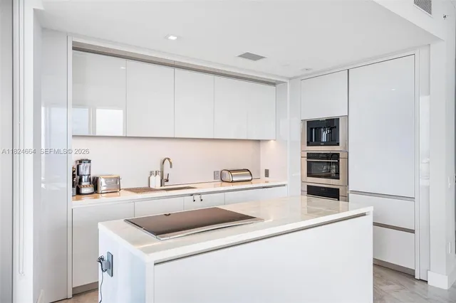 a utility room with cabinets washer and dryer