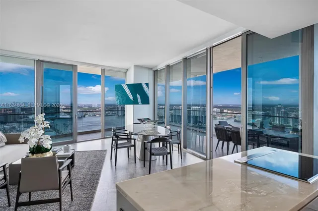 a dining room with furniture wooden floor and a floor to ceiling window