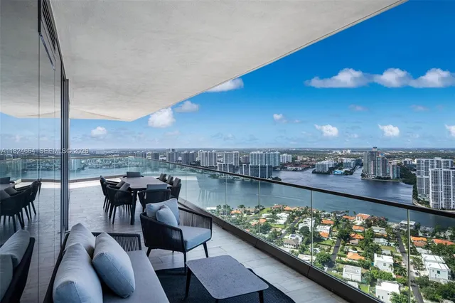 a view of a chairs and table in the balcony