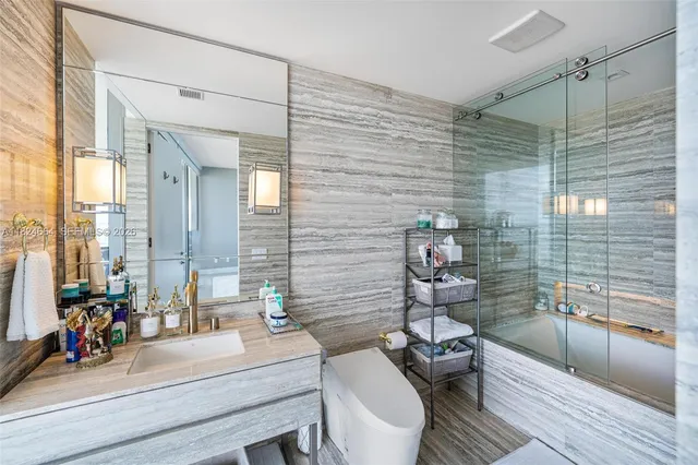 a bathroom with a sink mirror toilet and bathtub