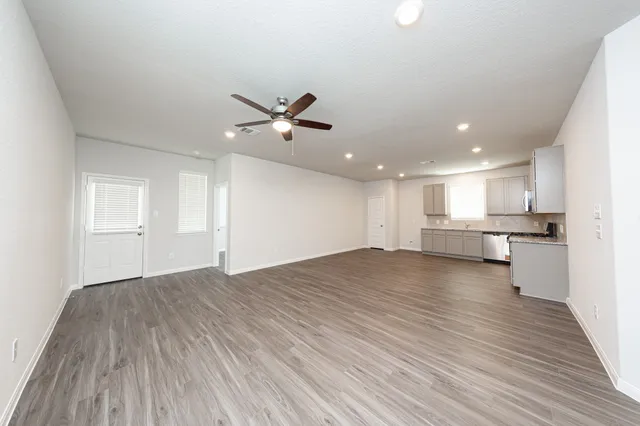 a view of a kitchen with a microwave and wooden floor