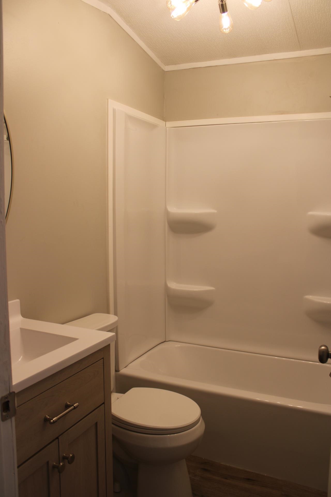 1535 Sand Ford Road Henning, TN 38041 - Photo 18 of 40 a bathroom with a sink a toilet and shower