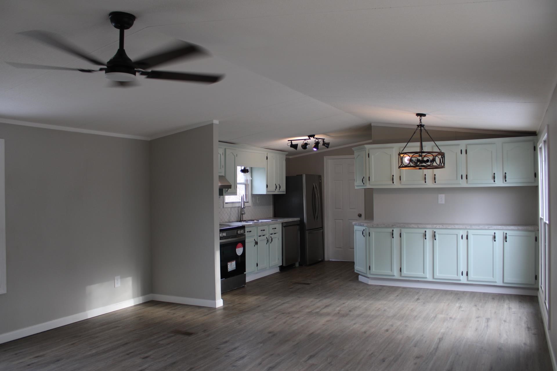 1535 Sand Ford Road Henning, TN 38041 - Photo 32 of 40 a view of a kitchen with a sink a refrigerator and a window