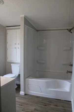 a view of an empty room and wooden floor