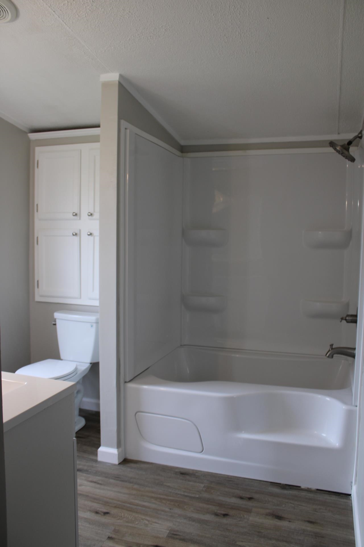 1535 Sand Ford Road Henning, TN 38041 - Photo 4 of 40 a bathroom with a bathtub and a shower