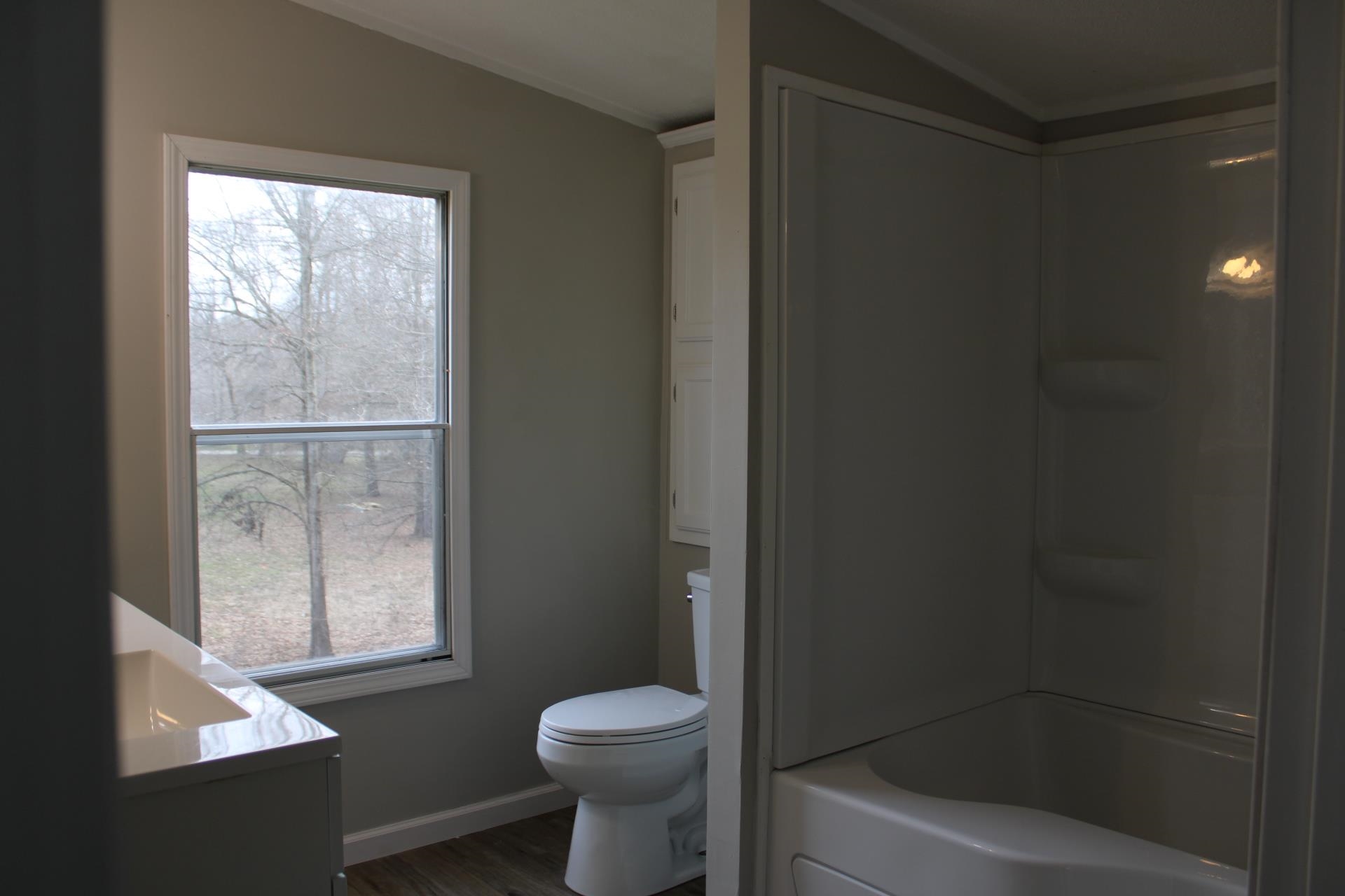 1535 Sand Ford Road Henning, TN 38041 - Photo 7 of 40 a bathroom with a toilet and a shower