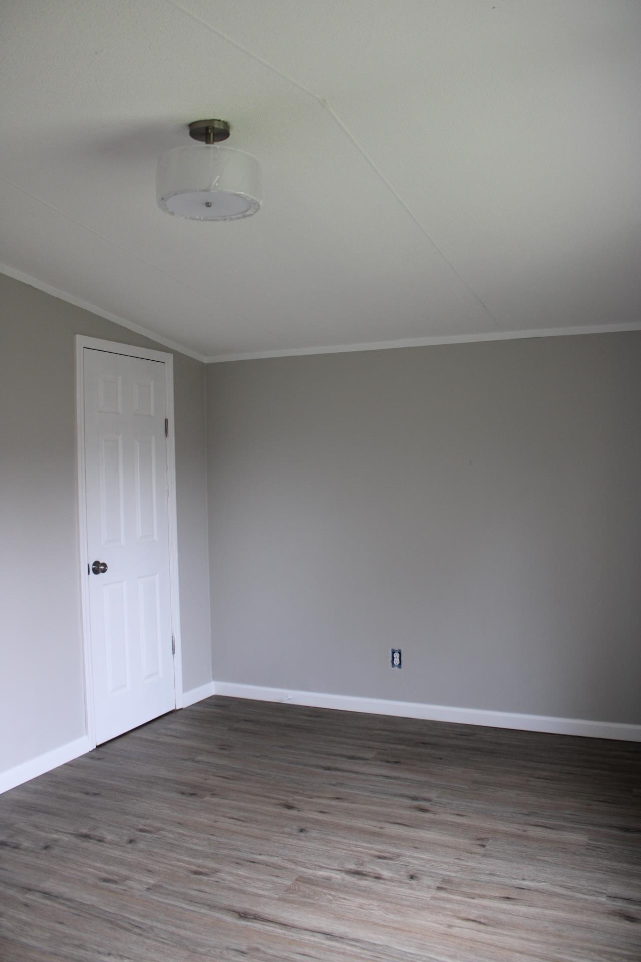 1535 Sand Ford Road Henning, TN 38041 - Photo 10 of 40 a view of an empty room and wooden floor