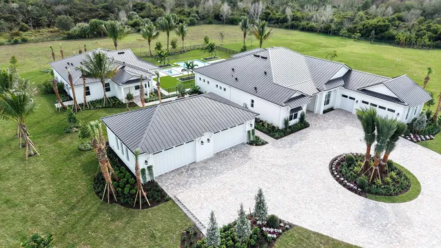 an aerial view of a house with garden space and street view