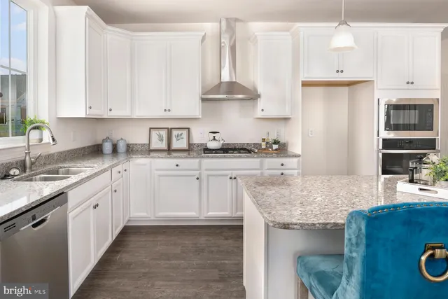 a kitchen with stainless steel appliances granite countertop a sink stove and cabinets
