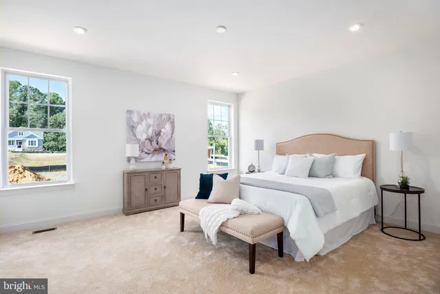 a spacious bedroom with a bed and a large window