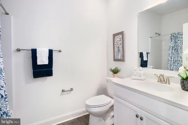a bathroom with a sink toilet and mirror