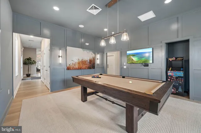 a room with pool table and a chandelier