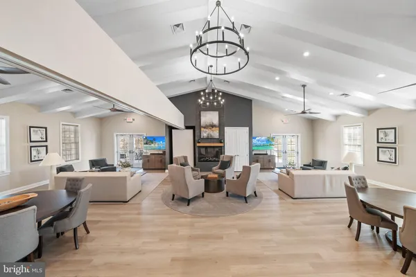 a living room with fireplace furniture and a chandelier