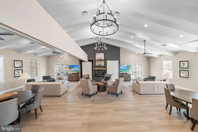 a living room with fireplace furniture and a chandelier