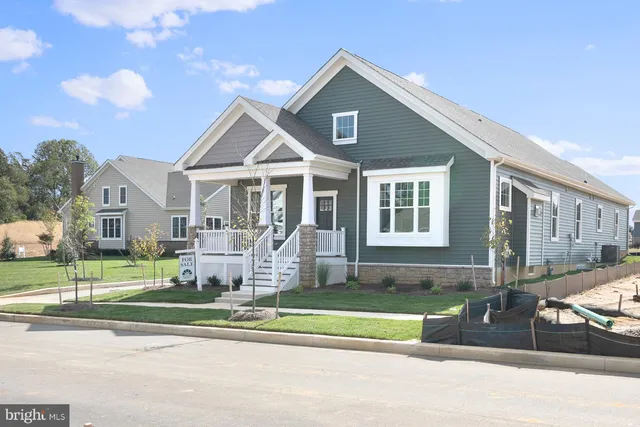 a front view of a house with a yard table and chairs
