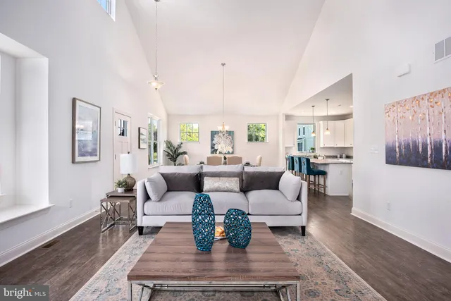 a living room with furniture wooden floor and a large window
