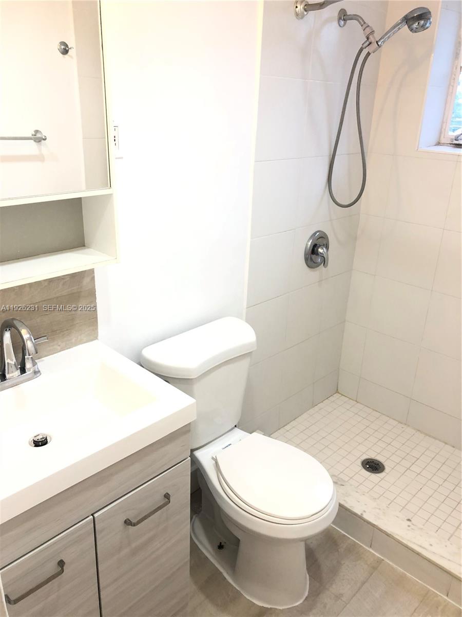 8340 Crespi Boulevard, Unit 19 Miami Beach, FL 33141 - Photo 21 of 35 a bathroom with a toilet sink and shower