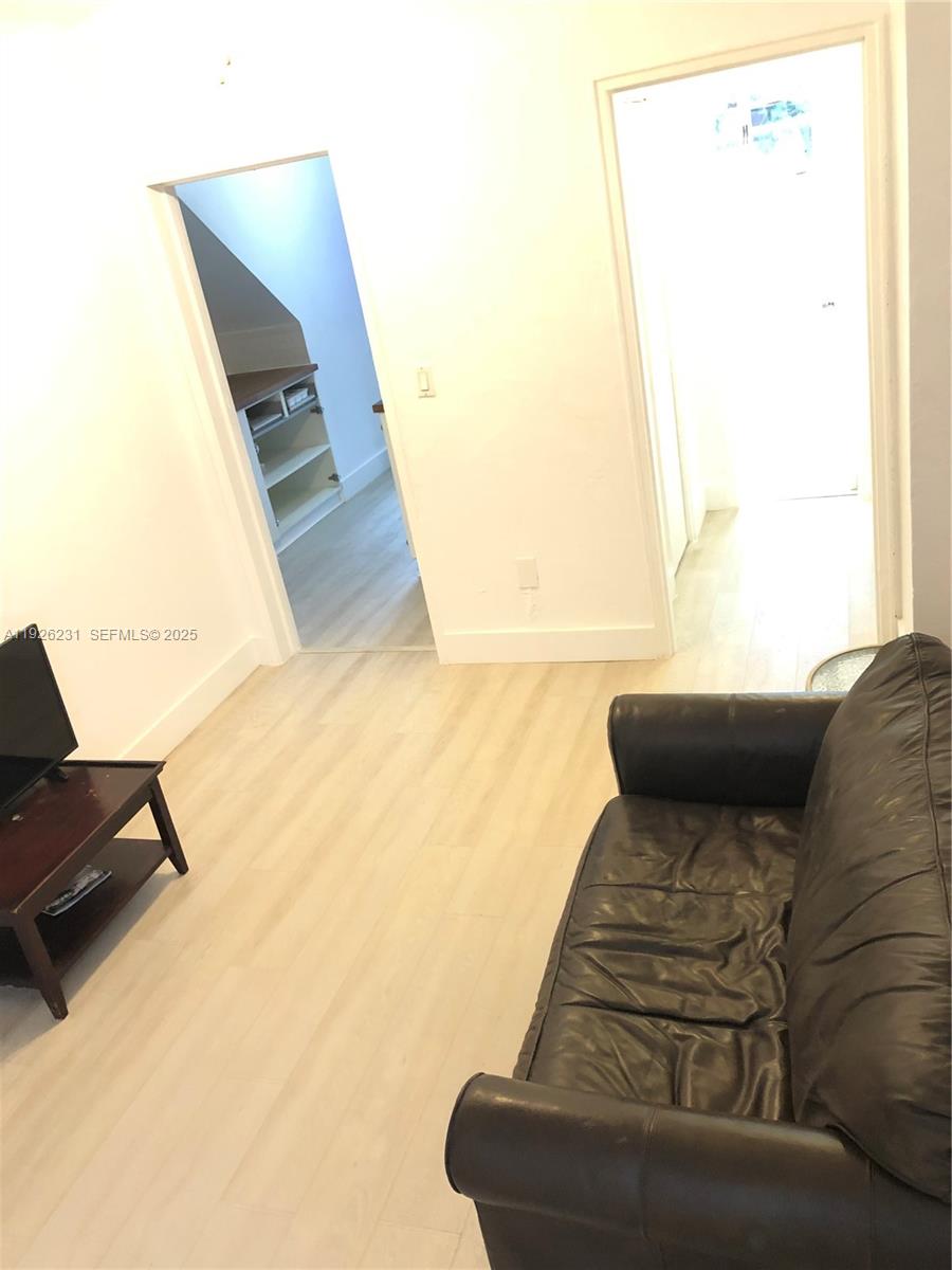 8340 Crespi Boulevard, Unit 19 Miami Beach, FL 33141 - Photo 23 of 35 a view of a couch in wooden floor