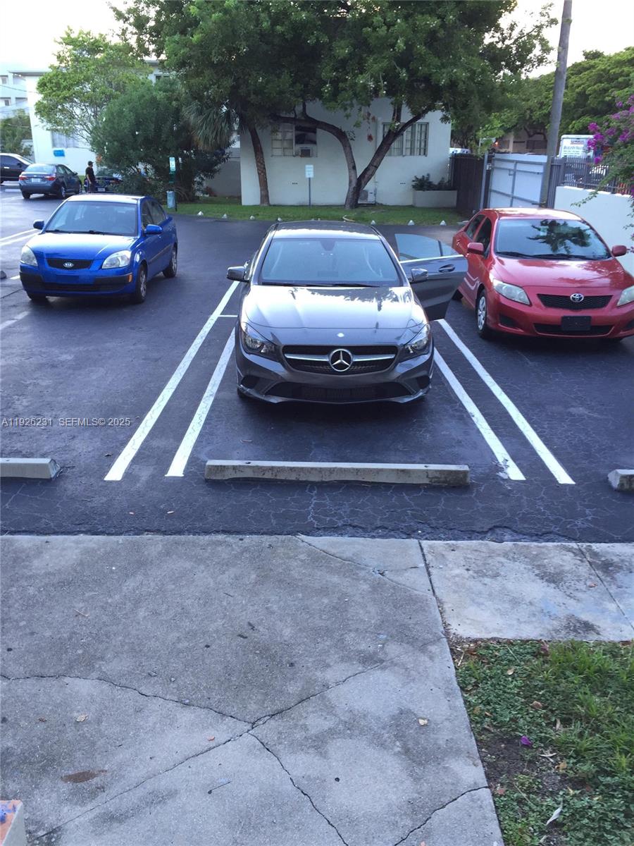 8340 Crespi Boulevard, Unit 19 Miami Beach, FL 33141 - Photo 29 of 35 a view of a cars park in front of a house