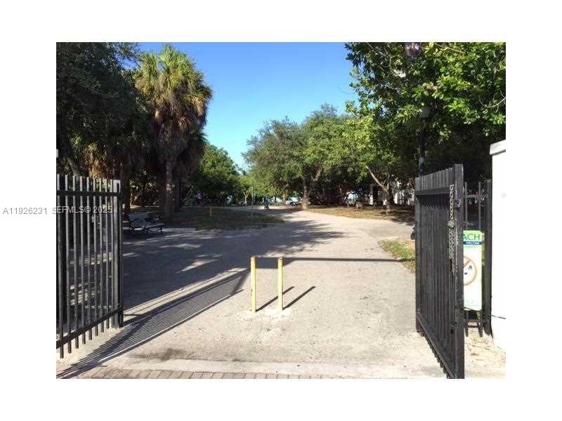 8340 Crespi Boulevard, Unit 19 Miami Beach, FL 33141 - Photo 6 of 35 a swimming pool with outdoor seating and yard