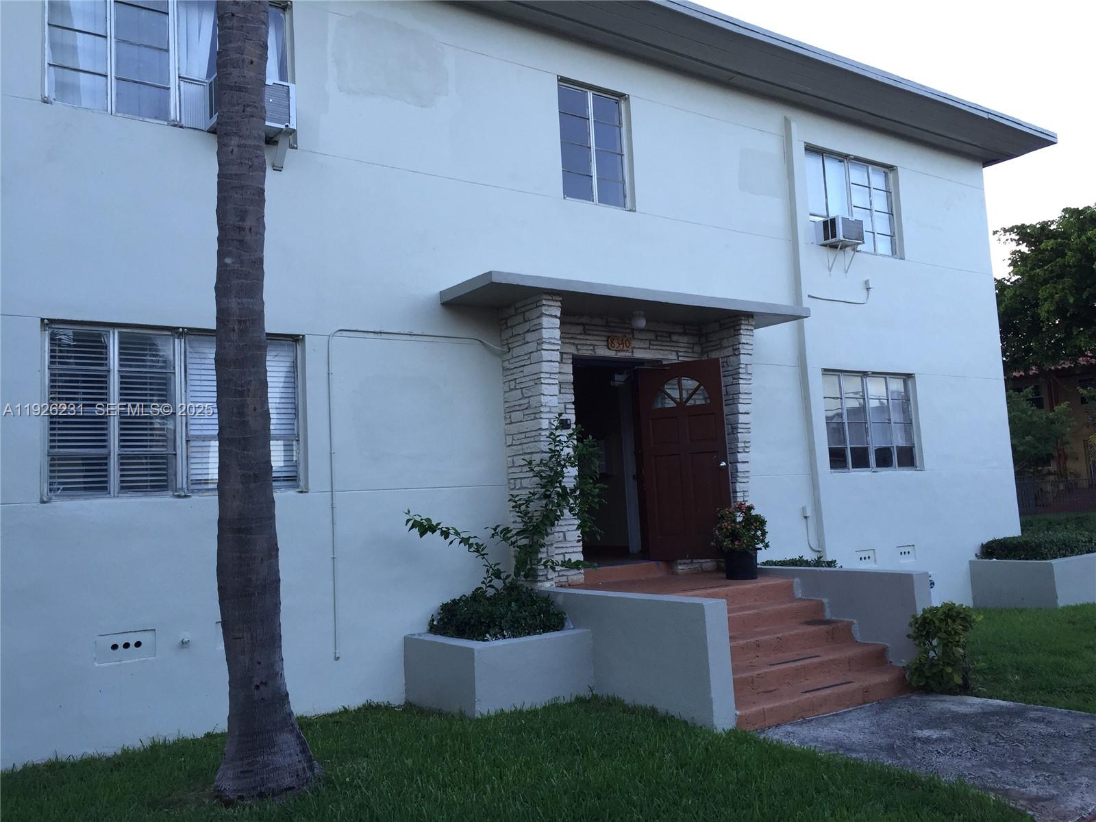 8340 Crespi Boulevard, Unit 19 Miami Beach, FL 33141 - Photo 9 of 35 a front view of a house with garden