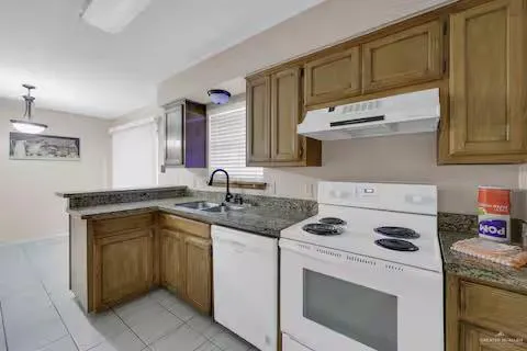 a kitchen with cabinets appliances a sink and a counter top space