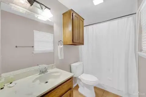 a bathroom with a sink toilet and mirror
