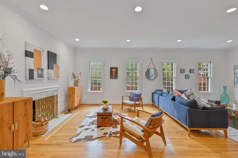 a living room with fireplace furniture and a wooden floor
