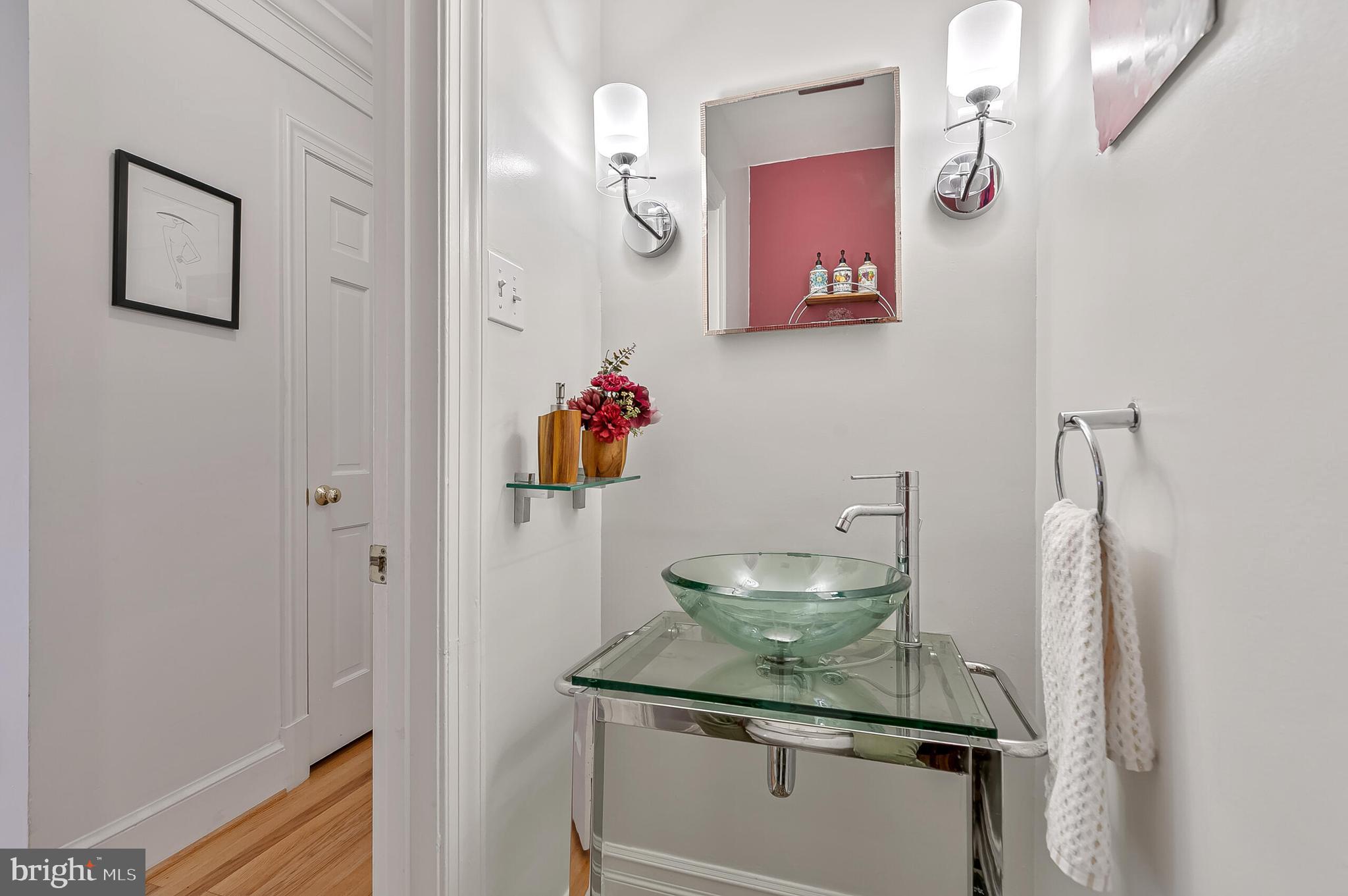 1340 North Lynnbrook Drive Arlington, VA 22201 - Photo 17 of 57 a bathroom with a granite countertop sink and a mirror