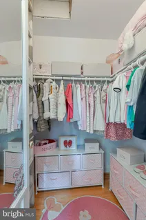 a bedroom with bed and a large window