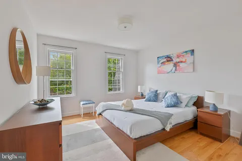 a bed room with a bed and a painting on the wall