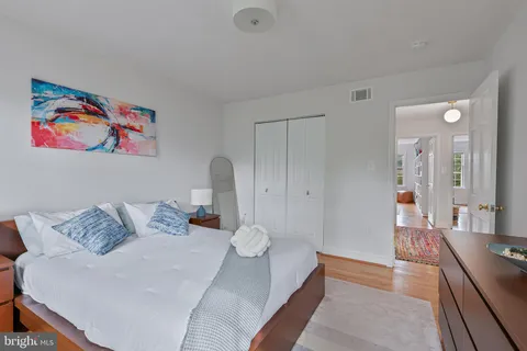 a bedroom with a bed couch and a window