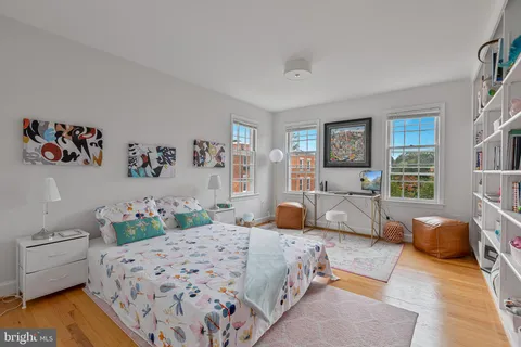a bedroom with a bed and a book shelf