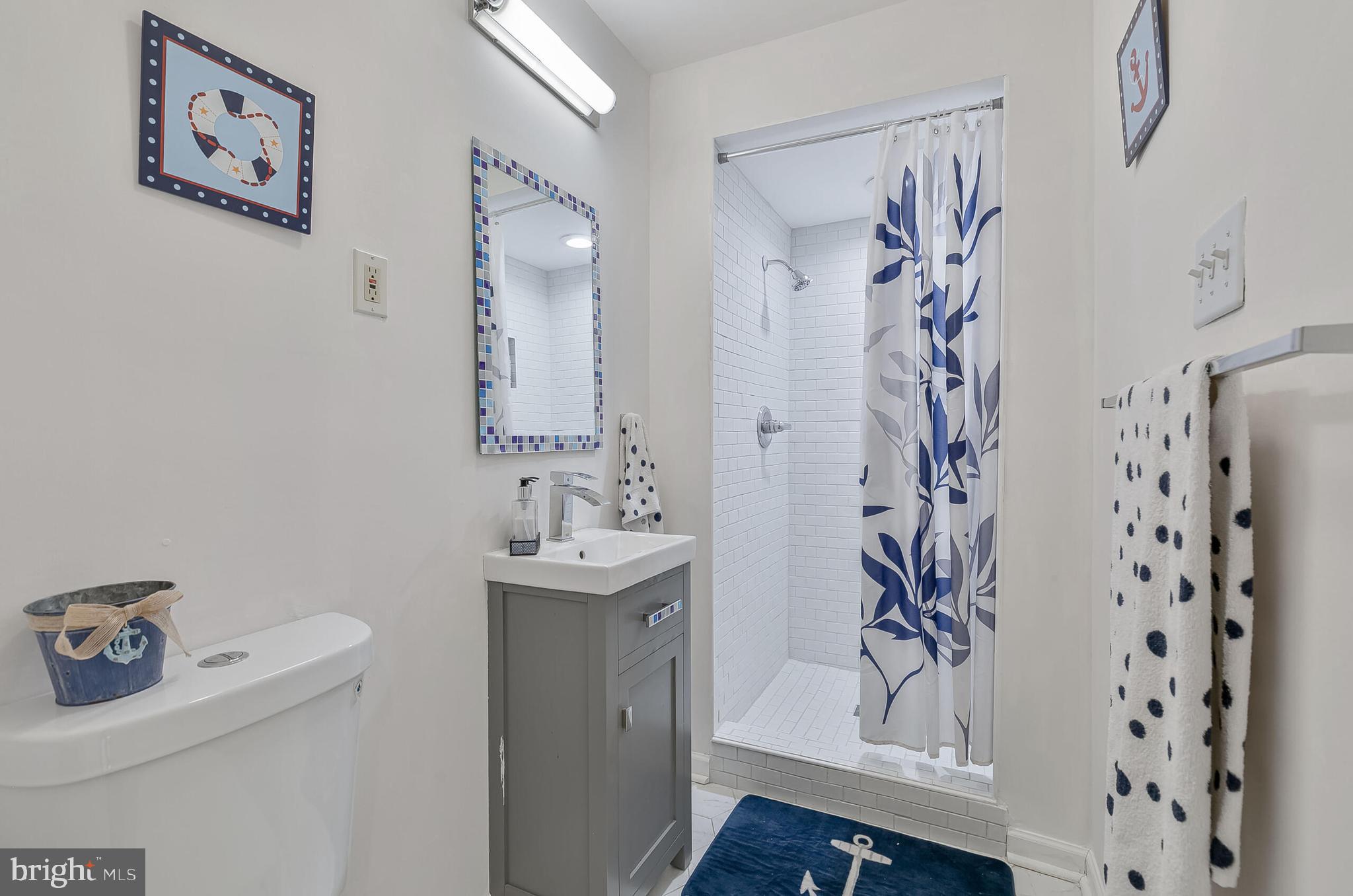 1340 North Lynnbrook Drive Arlington, VA 22201 - Photo 40 of 57 a bathroom with a shower curtain and a sink