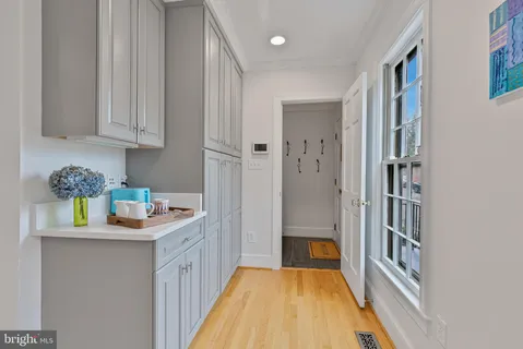 a kitchen with cabinets and a wooden floor